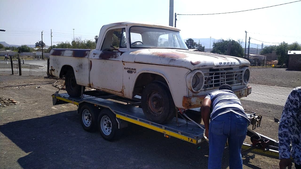 Dodge pickup strapped to a trailer for transport in South Africa