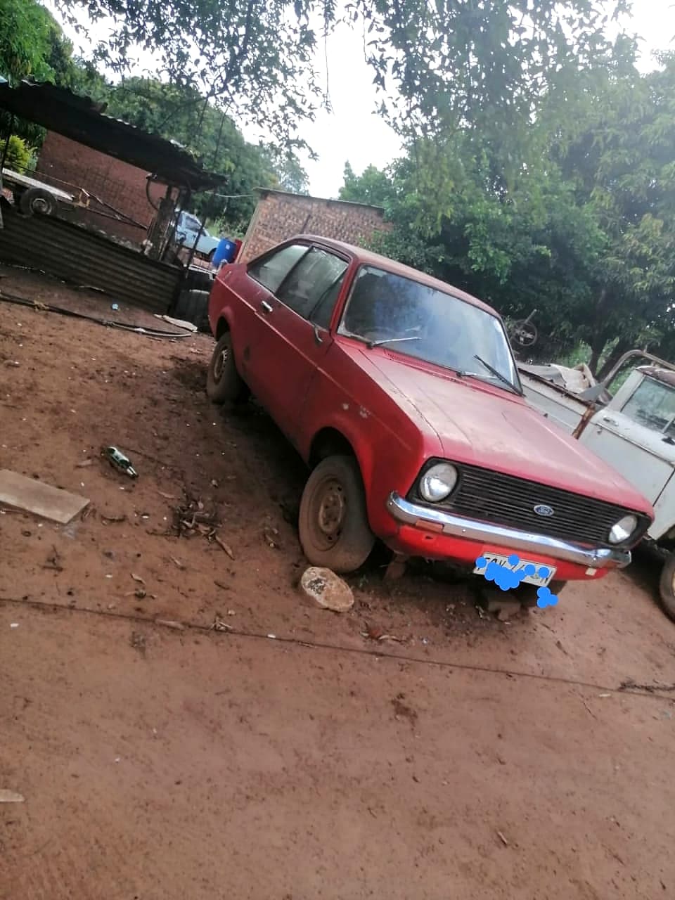 Red Ford Escort project car on red earth in Southern Africa