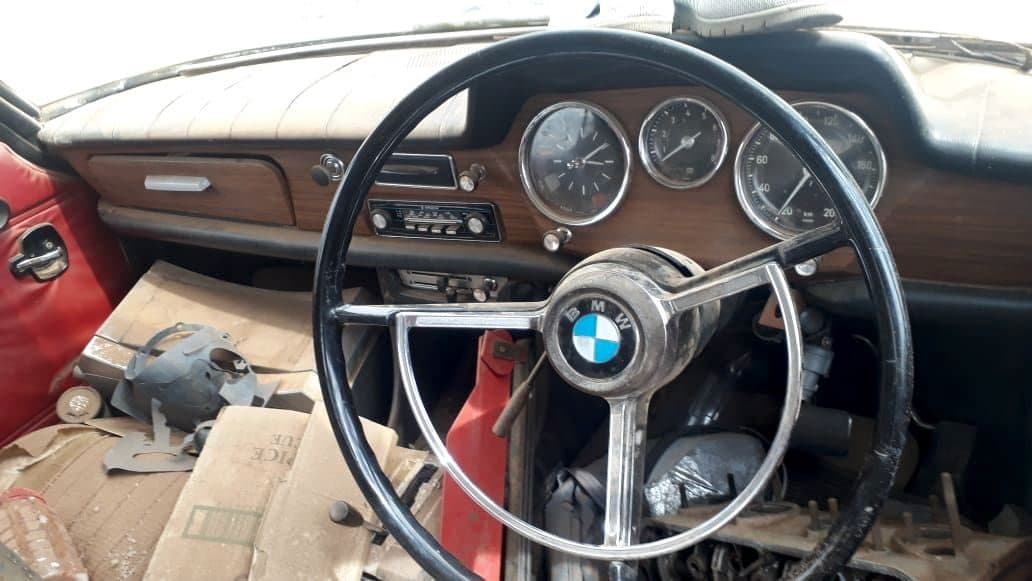 Classic BMW dashboard with wood trim, original gauges and period radio