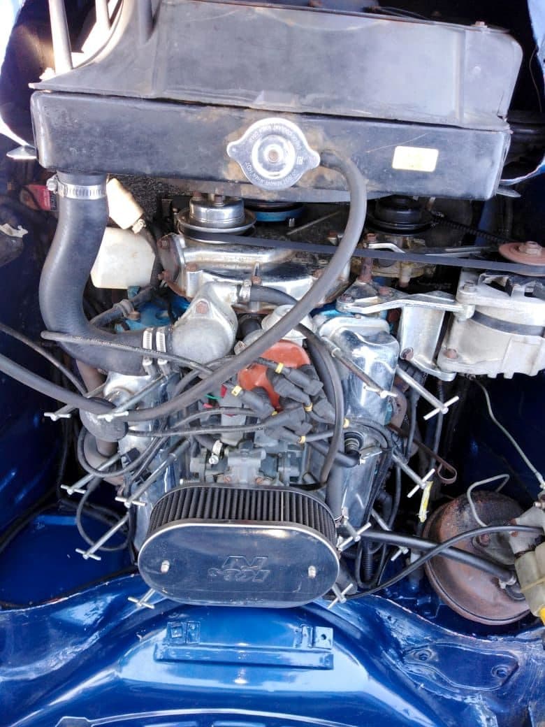 Blue classic car engine bay with K&N air filter and original radiator